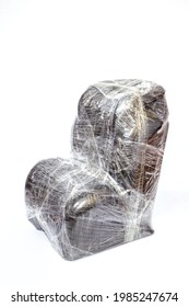 Baby Car Seat Wrapped In Plastic Wrap Isolated Closeup On Light Background