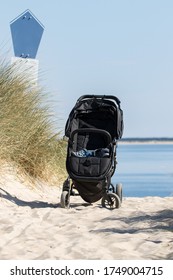 baby carriage on the beach in summer