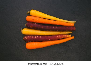 Baby Carrots Overhead On Dark Background