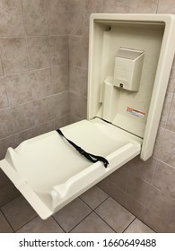 Baby Changing Table Station In A Men's Restroom Stall In Department Store Bathroom.