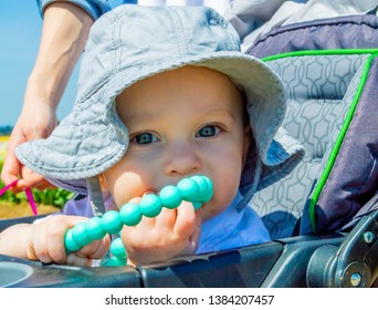 Baby Chewing The Teething Necklace