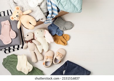 Baby And Child Clothes, Toys In Box. Second Hand Apparel Idea. Circular Fashion, Donation, Charity Concept