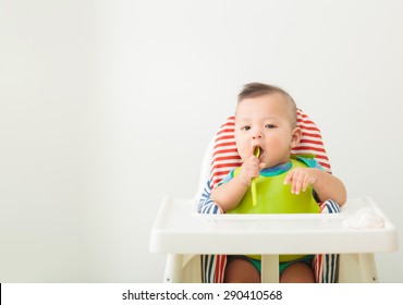 baby child eating in chair
