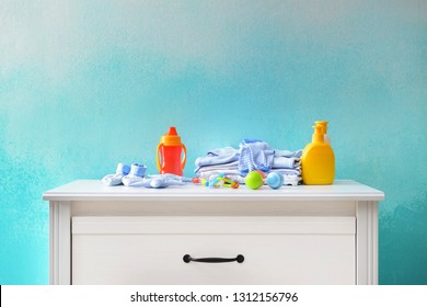 Baby Clothes And Accessories On Dresser