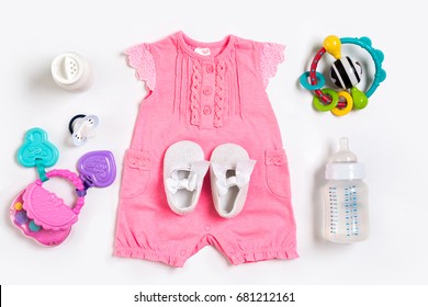 Baby Clothes And Accessories On White Background. Top View