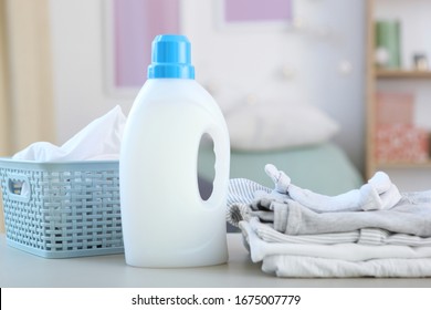 Baby clothes and detergents on the table. Baby clothes care concept. - Shutterstock ID 1675007779