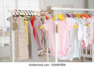 Baby Clothes Hanging On Rack In Store. Shopping Concept