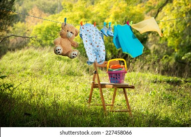 Baby Clothes On Clothesline Outdoors