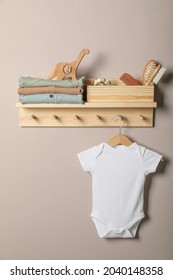 Baby Clothes, Toys And Accessories On Wooden Rack