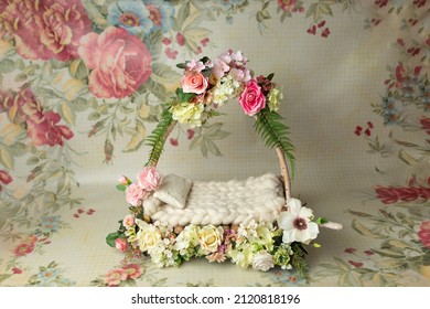 baby cot for a photo shoot of newborns. props for a photo shoot. the bed is decorated with pink roses. furniture for dolls