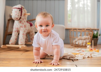 A baby is crawling on the floor in front of a rocking horse. The baby is smiling and he is enjoying the moment - Powered by Shutterstock