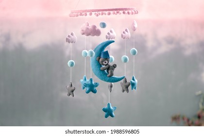 Baby crib hangings, Felt cot mobile made with plush clouds, moon, and stars. Space-themed handmade hanging. - Powered by Shutterstock