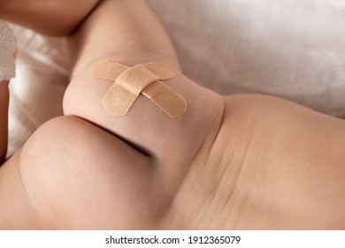 A Baby With A Cross Shape Adhesive Bandage On His Buttocks High Quality Photo