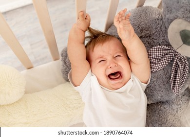 baby crying in his crib at home