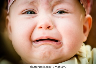 Baby crying - pure authentic emotion, tears visible
