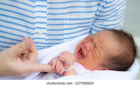 Baby Crying,Crying Innocent Baby,Asian Cute Baby Girl Hugging Her Mother Crying,Portrait Of A Loving Mother Holding Baby And Talking To Calm,Newborn Baby Girl Crying Portrait,Body Language Is Natural,