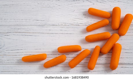 Baby Cut Carrots Abstraction On The White Table. Healthy Fresh Carrot On The Desk. Vitamin Food For Eyes