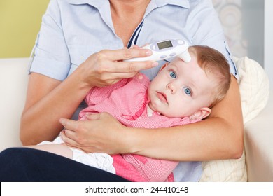 Baby With A Digital Thermometer