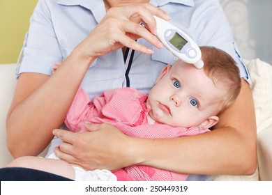 Baby With A Digital Thermometer