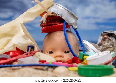 A Baby Doll Head Surrounded By Rubbish And Trash On A Beautiful Beach 