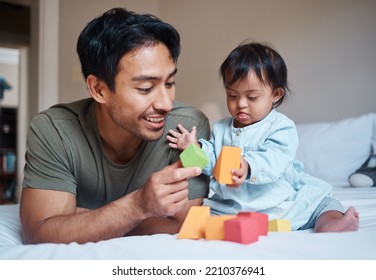 Baby, Down Syndrome And Learning On A Bed With Child And Father Playing With Educational Blocks In A Bedroom. Family, Disability And Kids Bonding With Asian Parent, Relax With Creative Activity