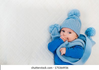 Baby Dressed In Winter Scarf And Cap