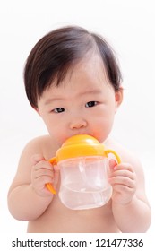 Baby drinking water from a bottle, asian child