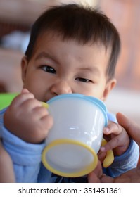 Baby Drinking Water From Cup, South East Asian Thai Baby Boy