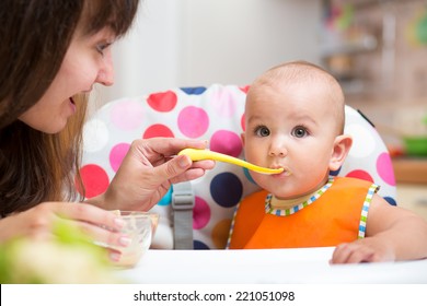 Baby Eating Food On Kitchen