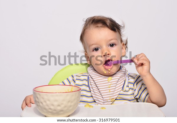 toddler using spoon