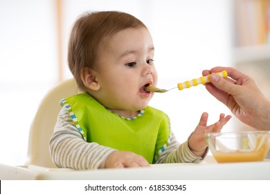 Baby Eating Healthy Food With Mother Help At Home