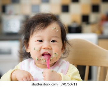 baby eating messy mashed potato