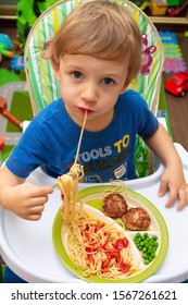 Baby Eating Spagetti With Tomato Sauce