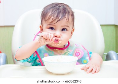 baby eating spoon - Shutterstock ID 663562348
