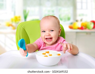 Baby Eating,happy Kid Have A Meal In Kitchen.Child's Nutrition.