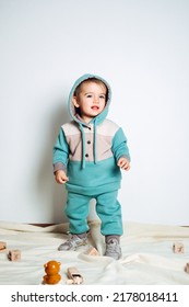 Baby Fashion. Unisex Clothes For Babies. Cute Baby In Cotton Set Suit On Light Background.