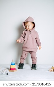 Baby Fashion. Unisex Clothes For Babies. Cute Baby In Cotton Set Suit On Light Background.