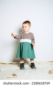 Baby Fashion. Unisex Color Clothes For Babies. Cute Baby Girls In Neutral Color Palette Cotton Dress