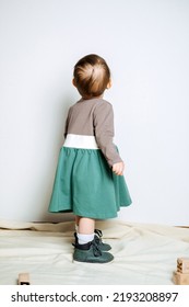 Baby Fashion. Unisex Color Clothes For Babies. Cute Baby Girls In Neutral Color Palette Cotton Dress