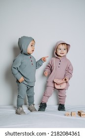 Baby Fashion. Unisex Gender Neutral Clothes For Babies. Two Cute Baby Girls Or Boys In Cotton Set