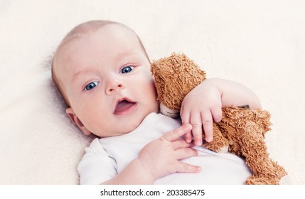 Baby With A Favorite Toy Supine