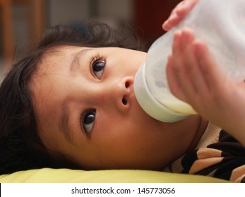 Baby feeding from bottle: Looking upwards