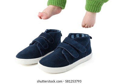 Baby Feet With Too Big Blue Child Shoes Isolated On White Studio Shot