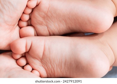 baby feet close up,A close-up of tiny baby feet,Baby feet on white coverlet. Toes. Feet how a heart or 