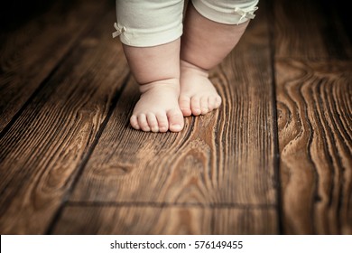 Baby feet doing the first steps. Baby's first steps. Baby feet . - Shutterstock ID 576149455
