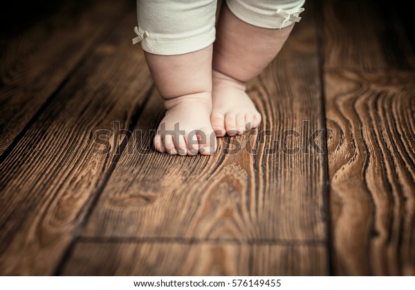 Baby feet doing the first steps. Baby\'s first steps.\
Baby feet .