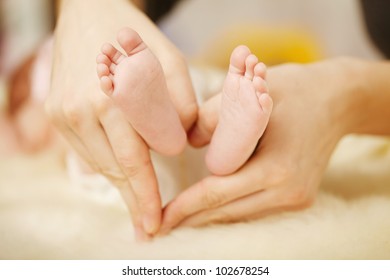 Baby feet in mommy's hands - Shutterstock ID 102678254