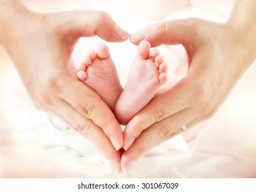 baby feet in mother hands - hearth shape
