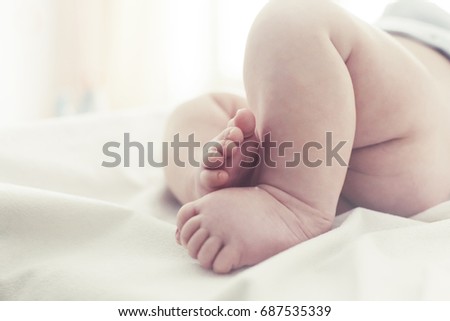 Baby feet in mother hands. Mom and her Child. Happy Family concept. Beautiful conceptual image of Maternity 