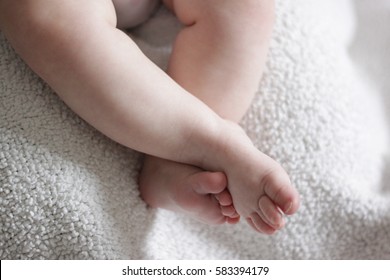 Baby Feet On Cozy Blanket, Legs Crossed